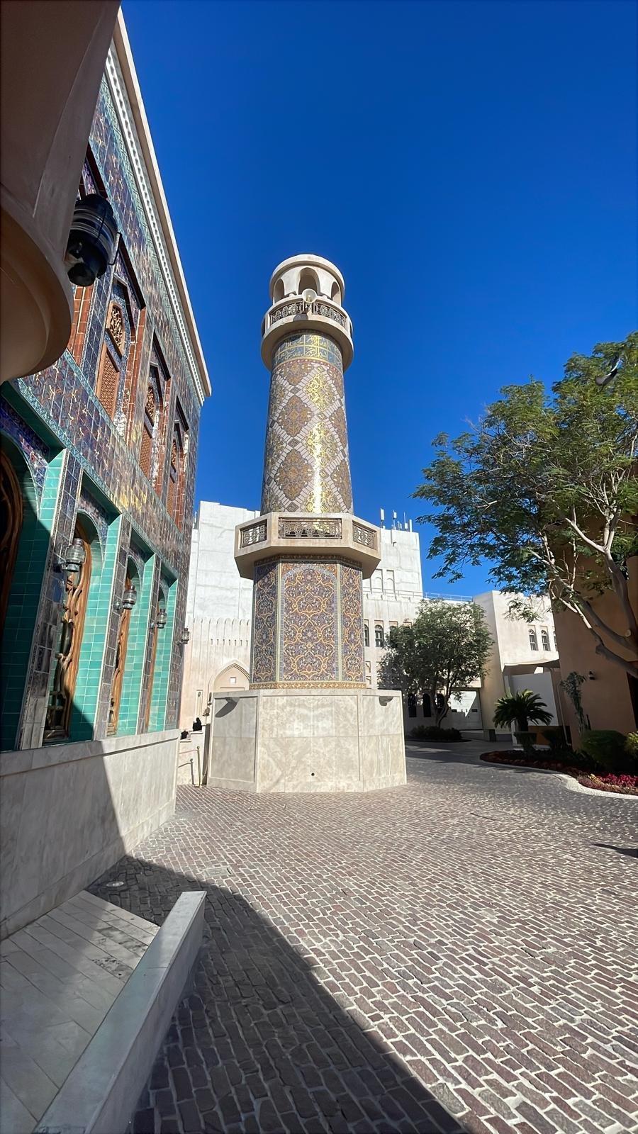 A whitewashed minaret above the lanes of old Doha